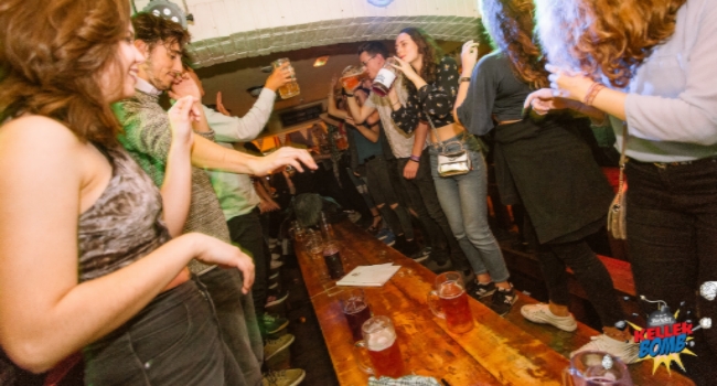 People dancing on tables at Kellerbomb in Bierkeller Leeds