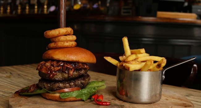 burger-topped-with-onion-rings-with-side-of-fries-from-the-navigation-inn-nottingham