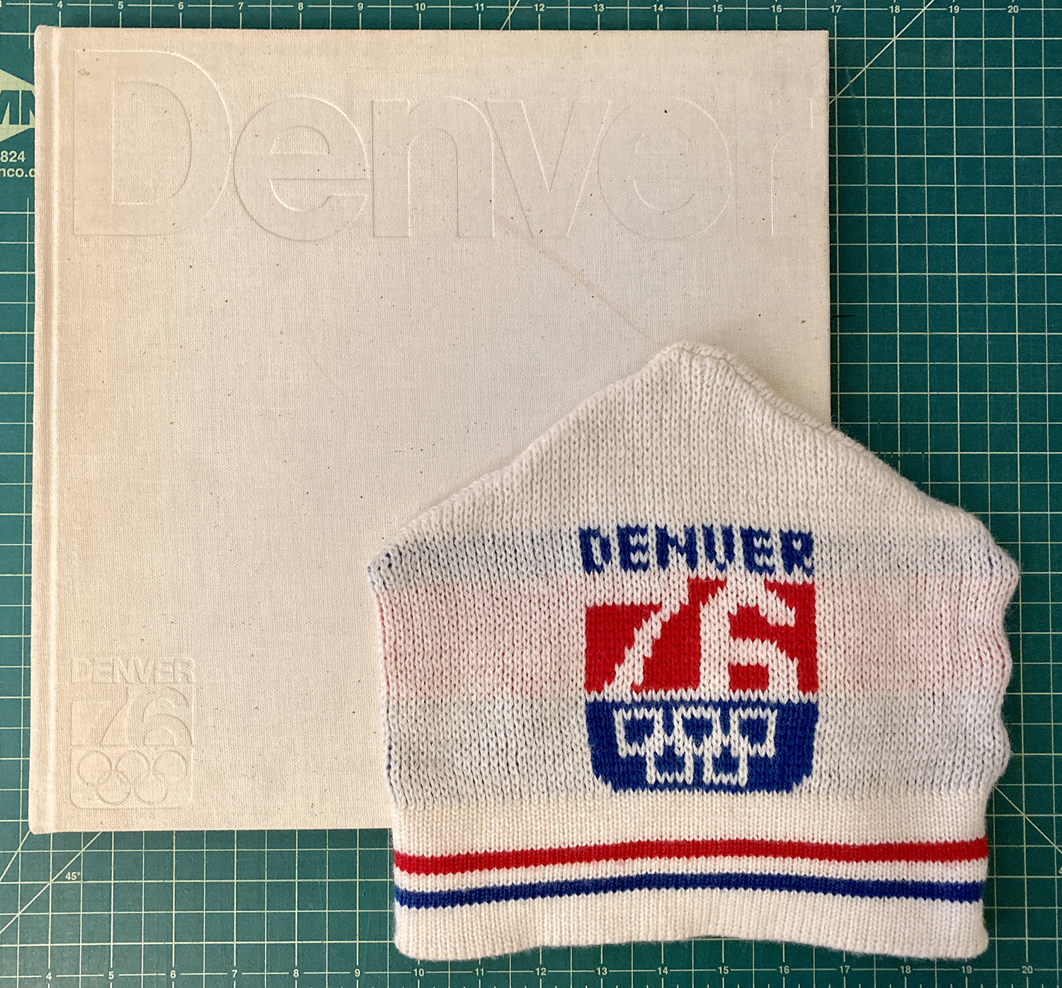 My personal Denver 76 collection which includes “The City” bid book and a beanie