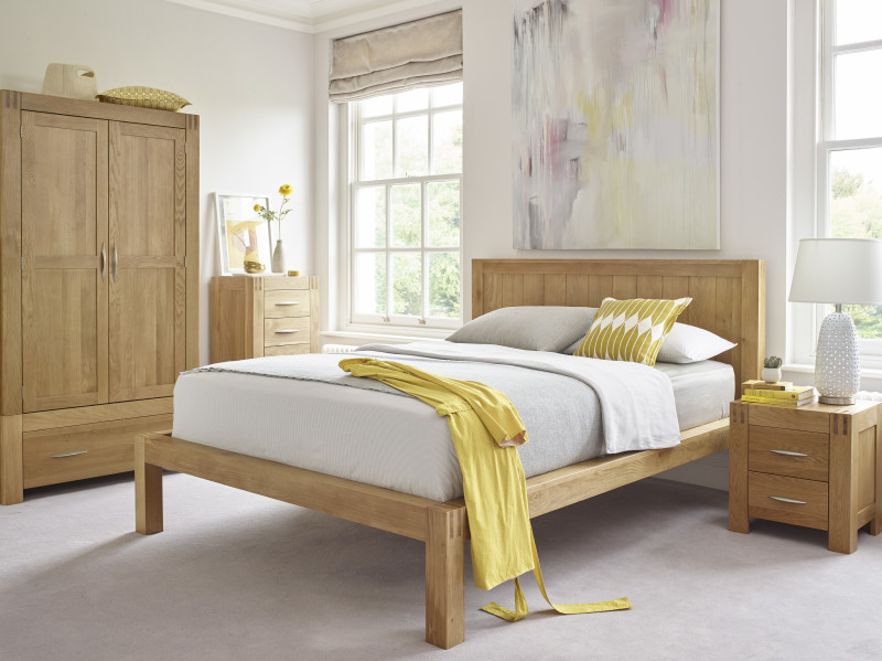 Natural oak bed, wardrobe, tallboy and bedside table in neutral bedroom