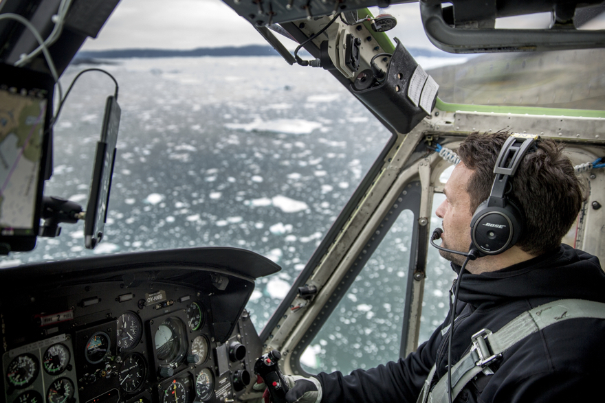 An Air Greenland Bell 212 helicopter pilot over the Ilulissat ice fjord in Greenland
