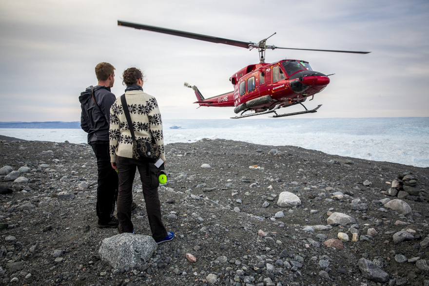An Air Greenland Bell 212 helicopter approaching a landing site near the Ilulissat ice fjord in Greenland
