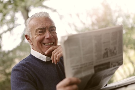Elderly man reading the paper