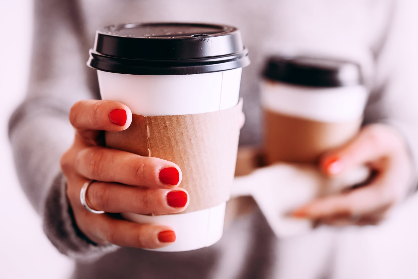 woman-hold-out-coffee-cup