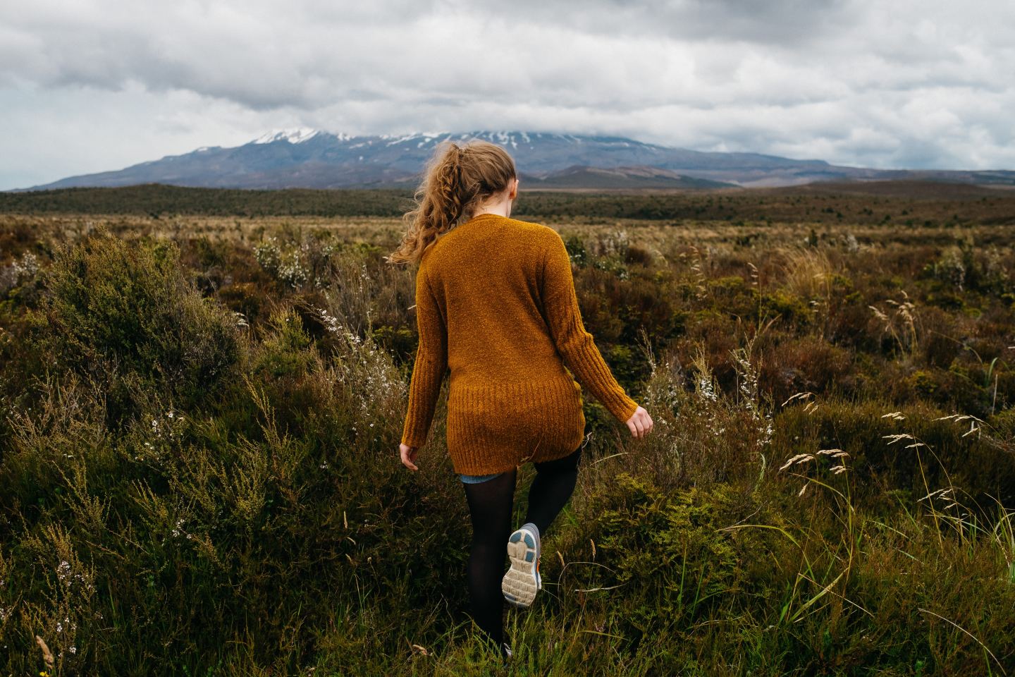 woman orange sweater field