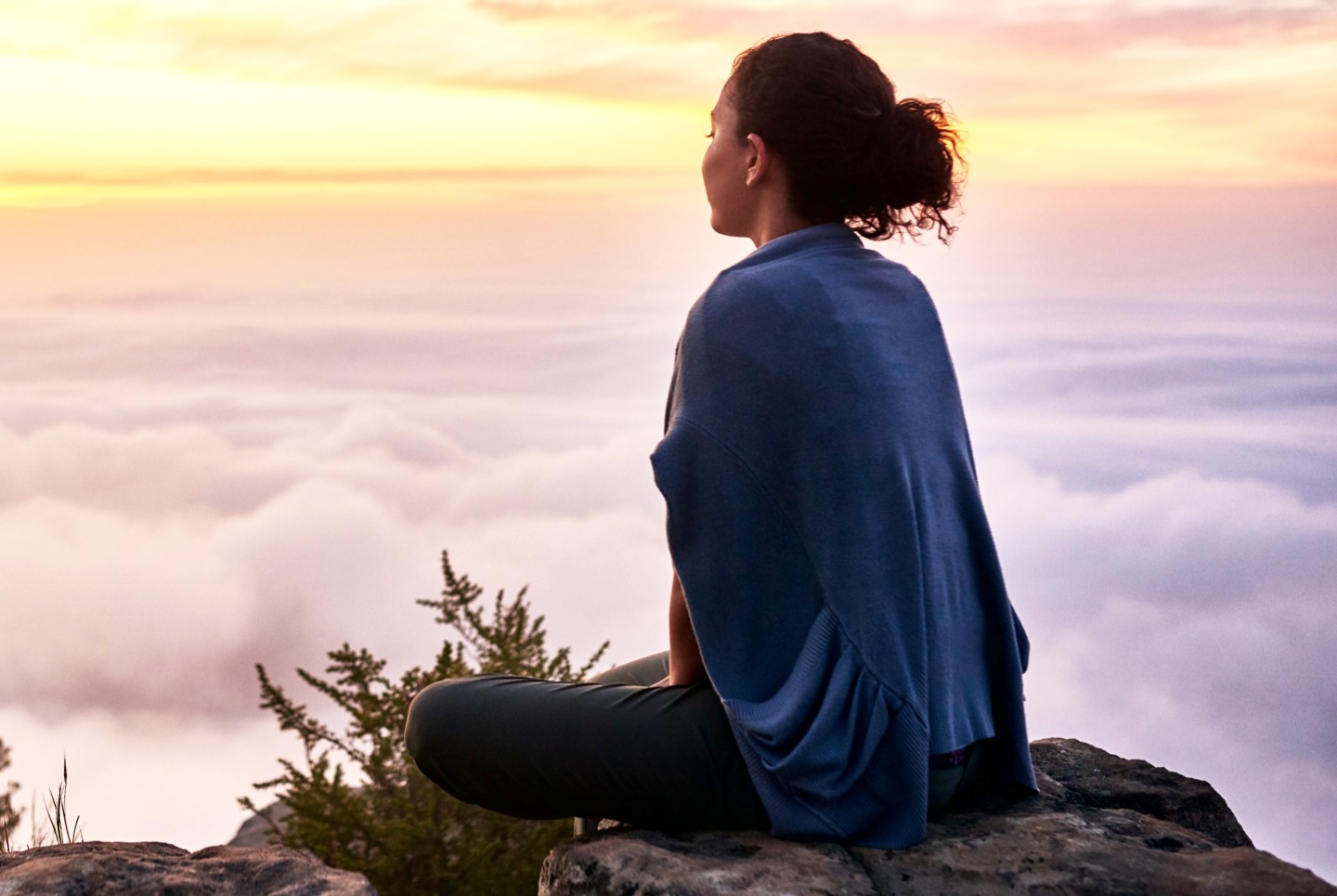 woman-sitting-above-clouds