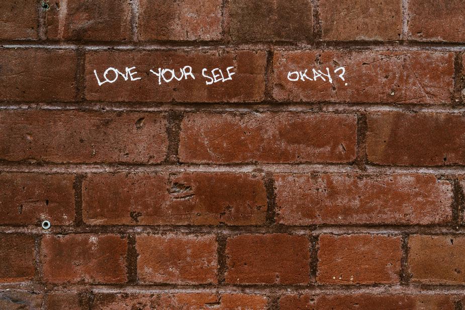 love yourself brick wall writing