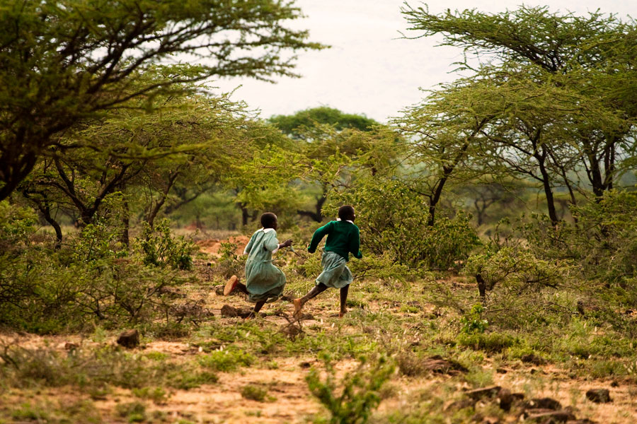 Girls running through bushland