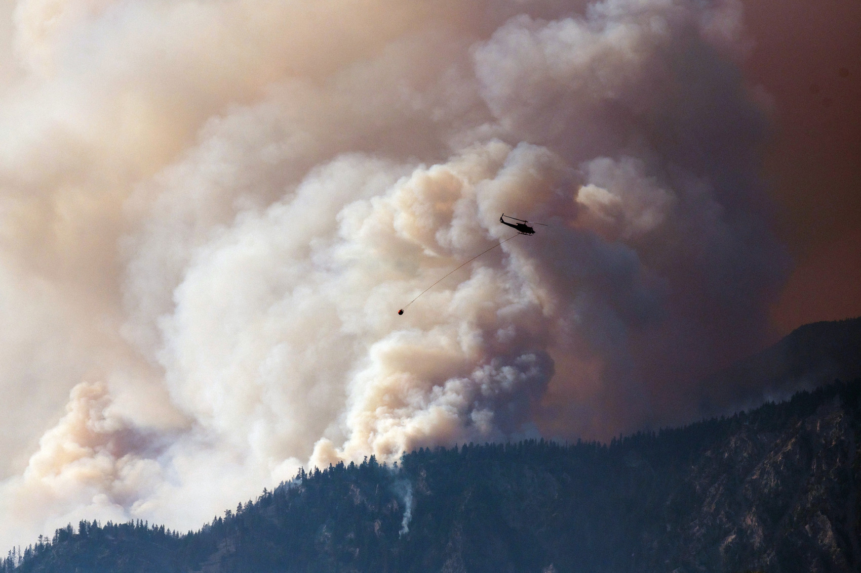 A helicopter fighting a wildfire in Lytton, British Columbia. (James MacDonald/ Bloomberg Creative/ Getty Images)