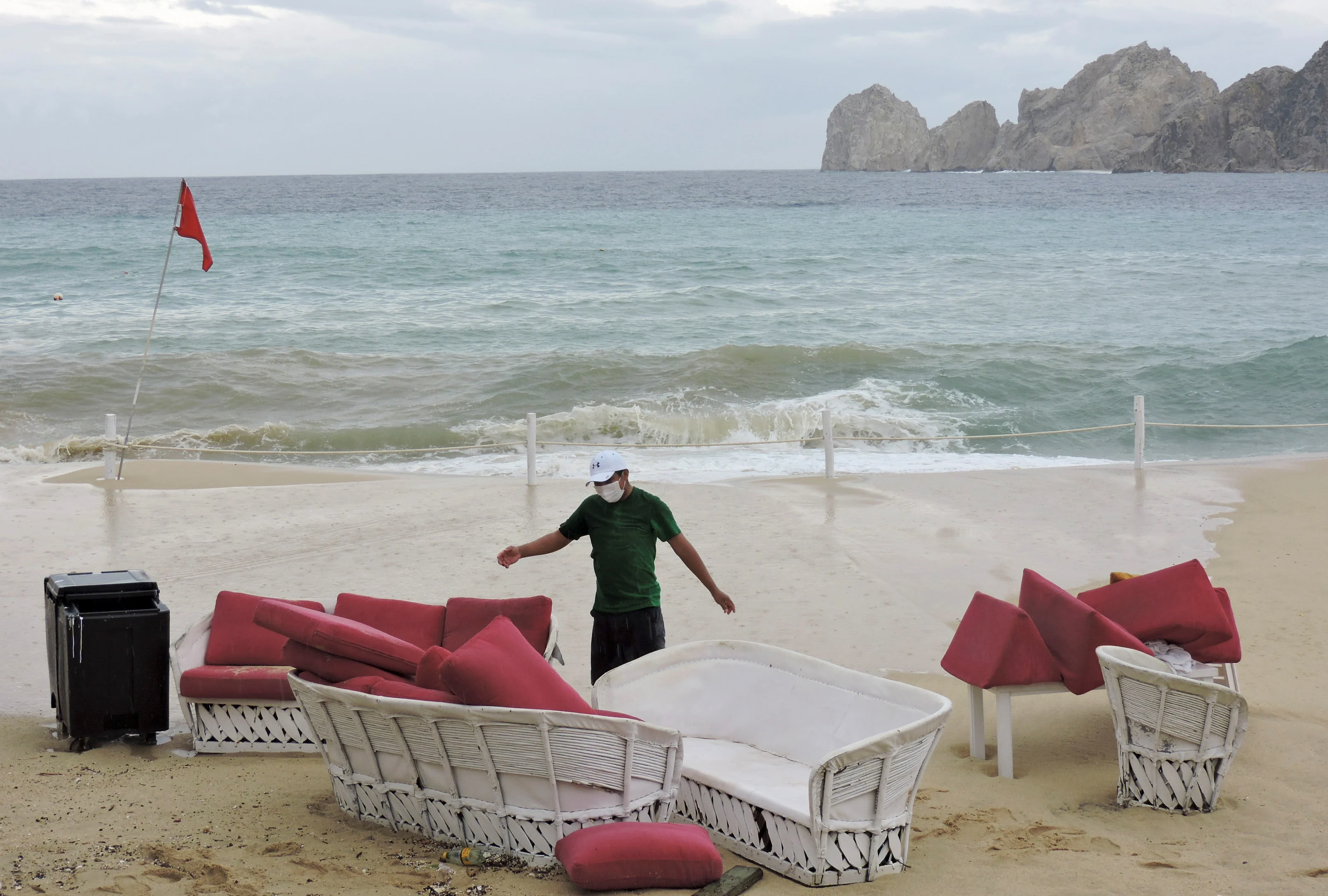 A restaurant employee removes furniture from Medano beach ahead of the arrival of Hurricane Olaf, in Cabo San Lucas, in Baja California Sur state, Mexico September 9, 2021. REUTERS/Monserrat Zavala