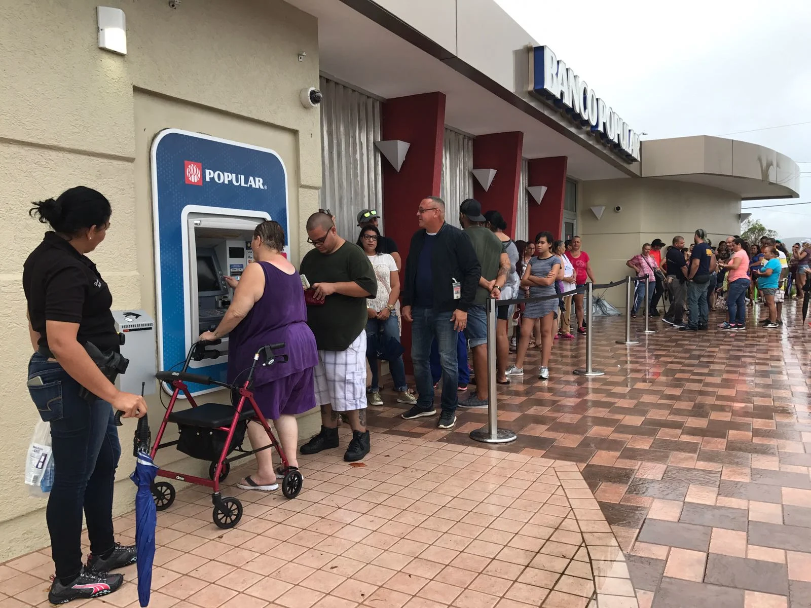 Residents of Ponce, Puerto Rico, line up at an ATM in hopes of getting some cash. More than a week after Hurricane Maria struck, residents are waiting in long lines to withdraw money and for gasoline