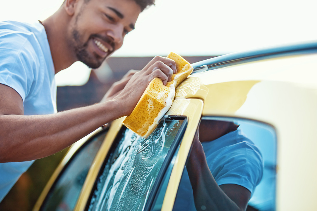 iStock-man washing yellow car