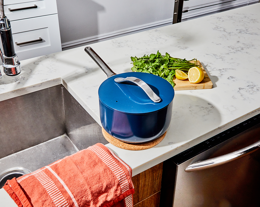 a blue sauce pan sitting on a kitchen counter