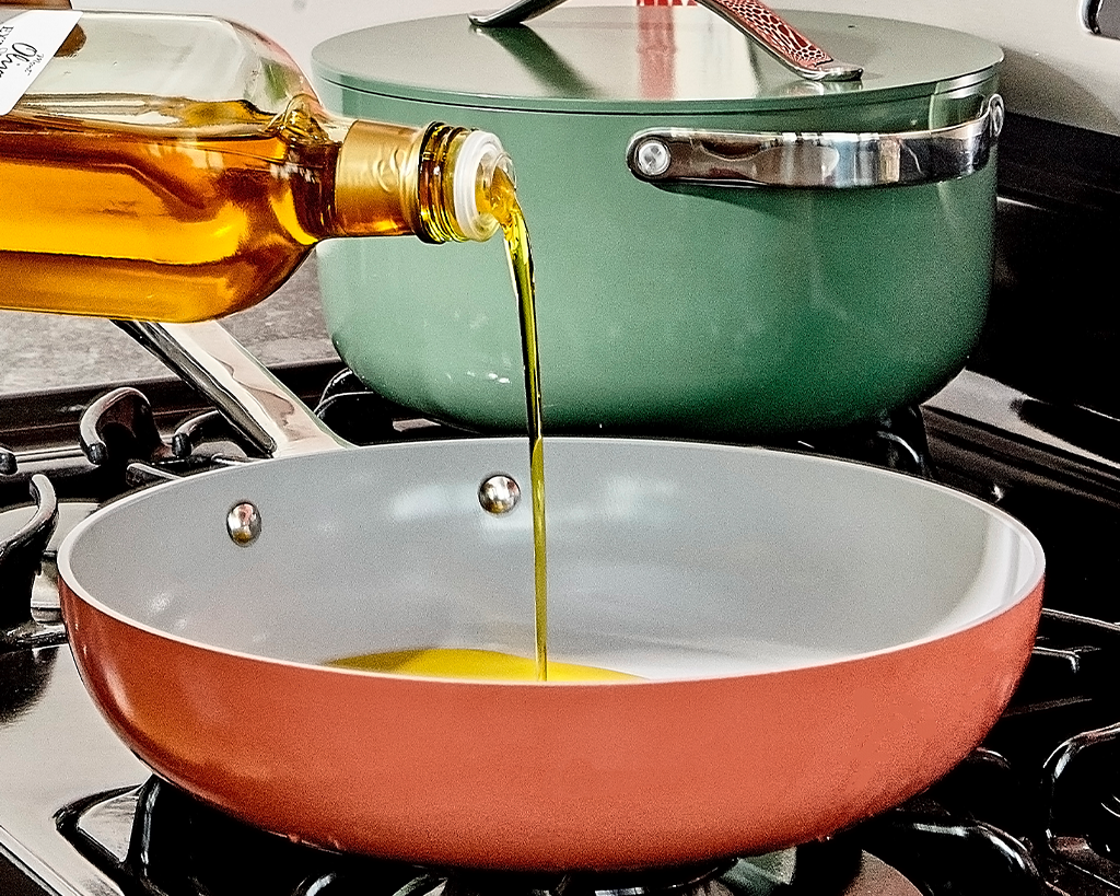 Pouring olive oil into a ceramic non-stick fry pan
