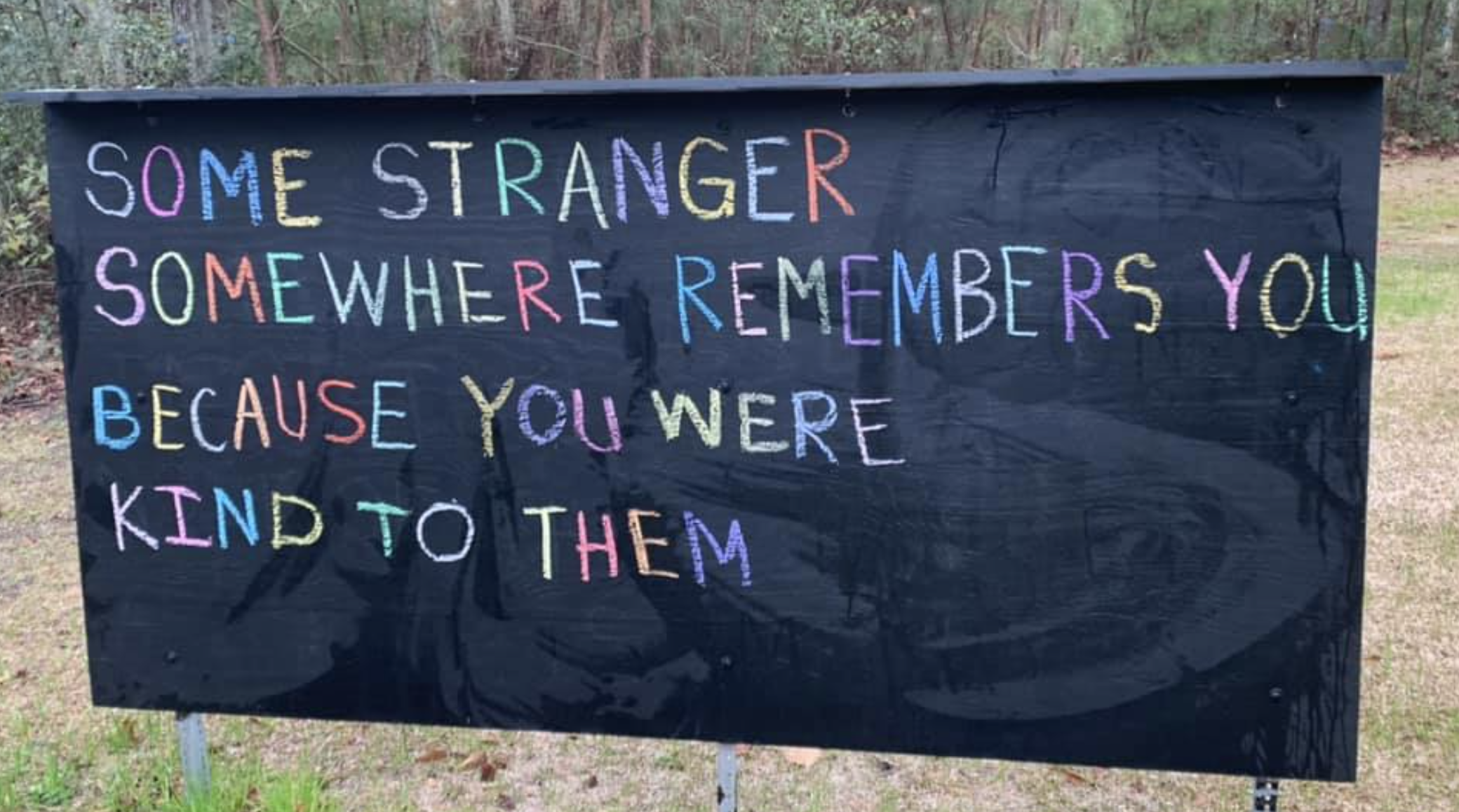 "Some stranger somewhere remembers you because you were kind to them" written on a sign with chalk