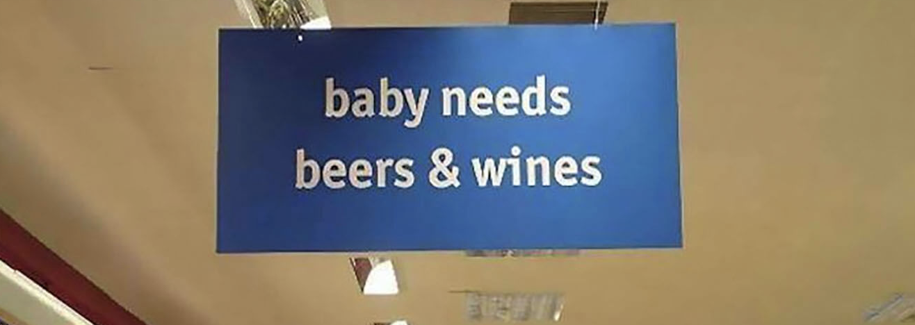 Sign with the words "Baby needs beers & wine"