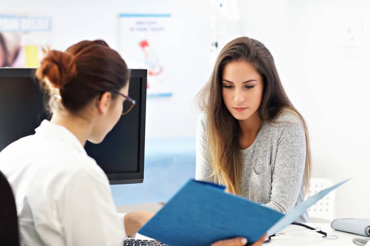 Woman talking to a doctor about abnormal vaginal discharge