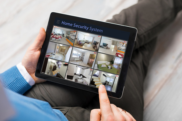 man-on-tablet-looking-at-security-system