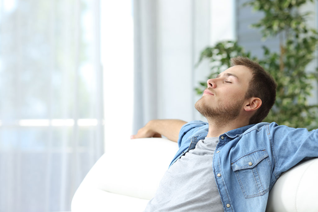 man sitting sitting on couch