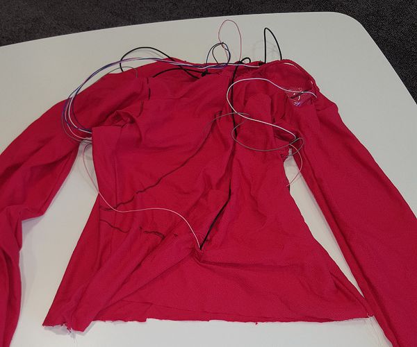 Futuwear clothing with conductive rubber cords and electrical wires visible