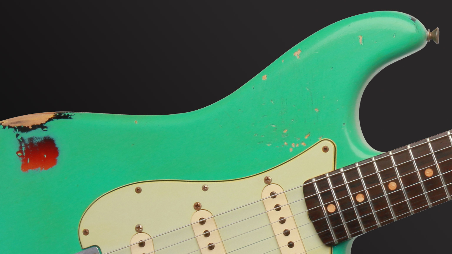 A Fender Custom Shop 1963 Stratocaster® Relic shows the kind of wear typically associated with a nitrocellulose lacquer finish, which this instrument has.