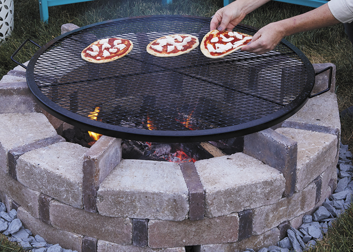 DIY firepit11:This grill grate sets nicely on the sqaure pavers and allows space to slip narrow logs in necessary.