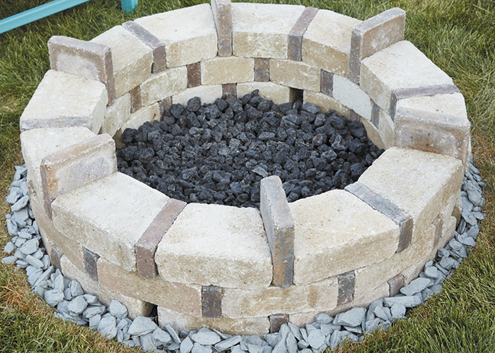 DIY firepit10:The porous lava rock drains quickly and will keep the base of the firepit dry detween rains.
