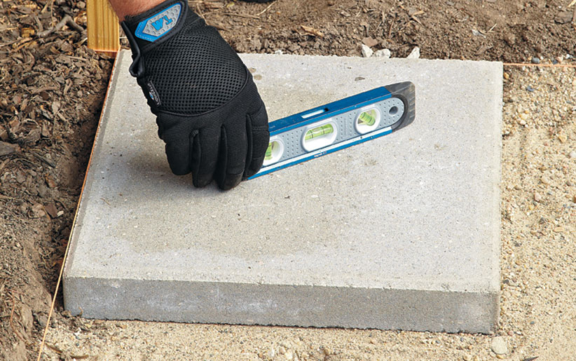 di-how-to-install-patio-step6: Start in one corner of the paver patio and work out from there.
