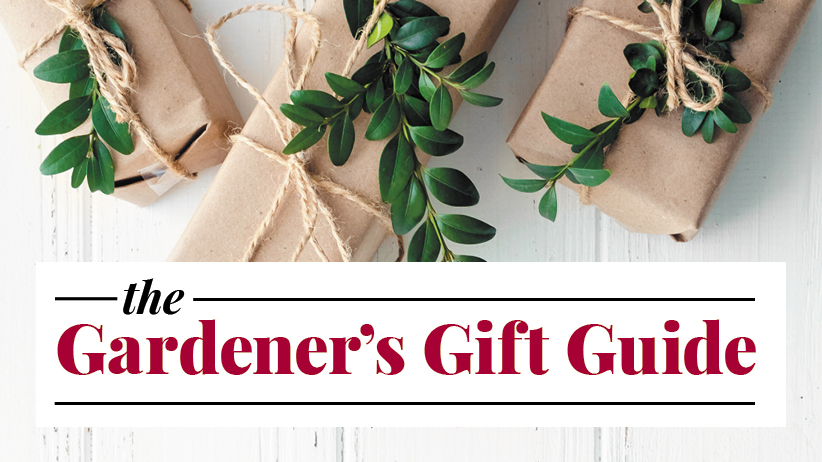2021 Gardener's Gift Guide with gifts wrapped in kraft paper with greenery tucked into the bows