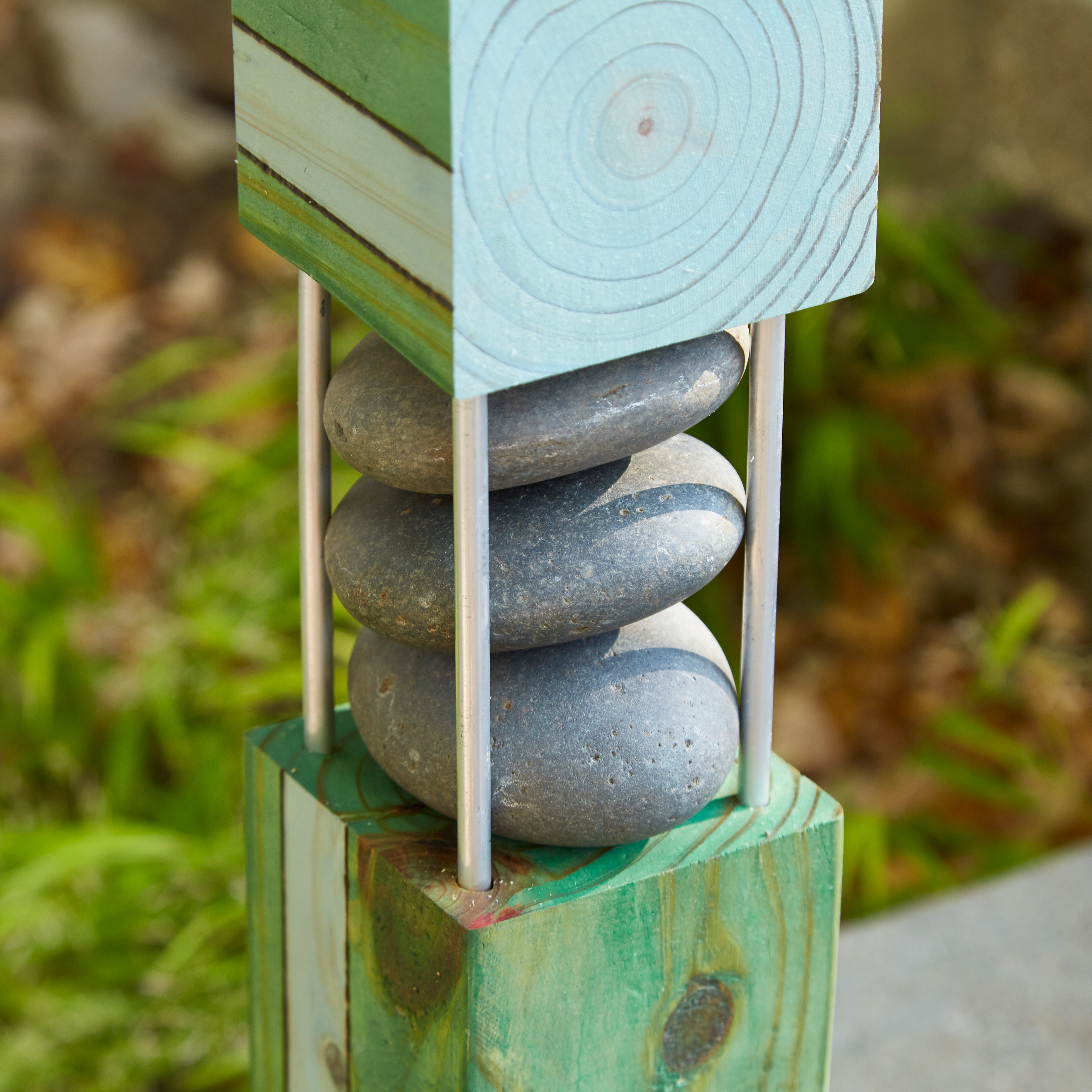 diy-garden-poles-river-rocks: Cut each 1/4-inch aluminum rod 2 inches longer than the height of the stack. Drill holes 1 inch deep.